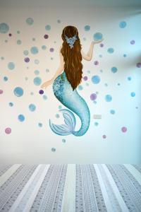 a mermaid wall mural in a room at Private room in Halong center-Almor Homestay in Ha Long