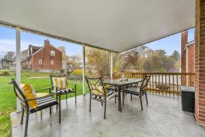 a patio with a table and chairs on a balcony at Spacious Home, 15min from Downtown, Private Garage & Patio in Pittsburgh
