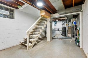 an empty garage with a staircase in a wall at Spacious Home, 15min from Downtown, Private Garage & Patio in Pittsburgh