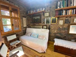 a room with a bed in a room with bookshelves at Stone House with Garden in Cunda/Ayvalik in Ayvalık