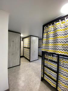 a row of lockers in a room with yellow and brown stripes at My Hostel Pavlodar in Pavlodar