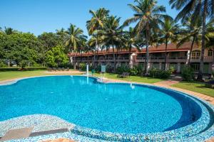 a large swimming pool in front of a resort at Nanu Beach Resort & Spa in Betalbatim