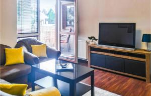 a living room with a couch and a television at Apartment Beautiful in Ostróda