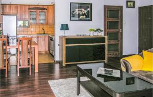 a living room and kitchen with a couch and a table at Apartment Beautiful in Ostróda