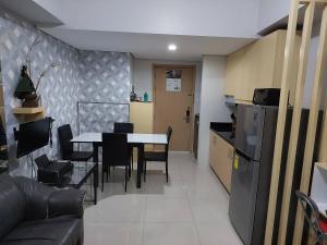 a kitchen and dining room with a table and a refrigerator at Jeffrey Paradero - Fern Residence Tower 4 in Manila
