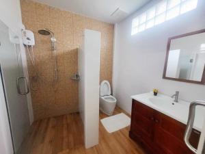 a bathroom with a shower and a toilet and a sink at Himaphan Boutique Resort - SHA EXTRA PLUS in Nai Yang Beach