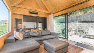 a living room with a couch and a table at Picture Perfect - Queenstown Holiday Home in Queenstown