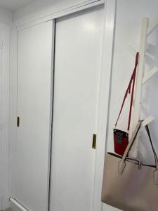 uma porta de vidro num quarto com uma cesta vermelha em Oasis Plus em Sevilha