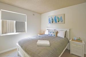 un dormitorio con una cama y una ventana en Waterviews on Marine Apartment 1, en The Entrance