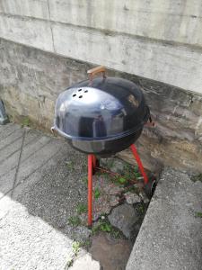 a grill sitting on a stand on the street at Semplice casa in Bellinzona