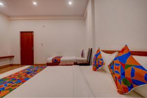 a bedroom with two beds in a room at FabHotel Sri Udupi Park in Bengaluru