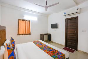 a bedroom with a bed and a tv in a room at Via The Prasiddh in Agra