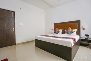 a bedroom with a large bed in a room at Via The Prasiddh in Agra