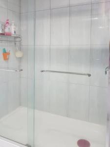 a shower with a glass door in a bathroom at private single room in a house in Richmond