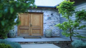 a wooden door on the side of a house at Amaroo in Bowral +17 photos