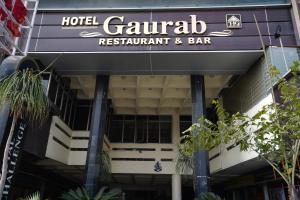 a hotel garantiana restaurant and bar with a sign at Hotel Gaurab Near Railway Station in Dehradun