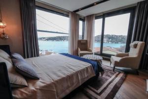 a bedroom with a large bed and large windows at Unique Bosphorus view of historical Istanbul. in Istanbul
