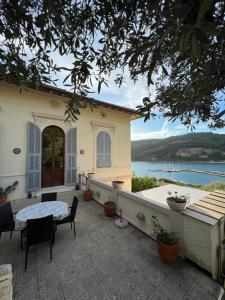 a house with a patio with a view of the water at Villa Paolo Lemon Tree in Portovenere