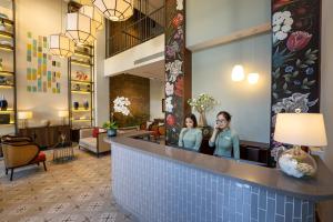 a lobby of a hotel with two women in the mirror at Cozy Danang Boutique Hotel in Danang