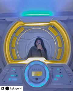 a woman taking a picture in a washing machine at Tab Hotel Legian Bali in Seminyak