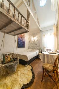 a bedroom with a swinging bed and a swing chair at Silsopa Hostel in Nong Khai
