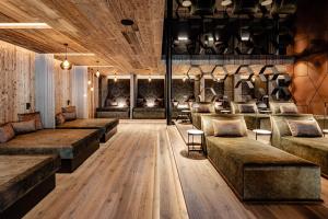 a room with couches and tables in a room at Alpine Luxury SPA Resort Schwarzenstein in Lutago