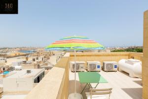 a colorful umbrella sitting on top of a roof at LIVE like a Local - 3 Cities Home & 2 KING BED by 360 Estates in Cospicua