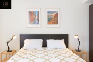 a bedroom with a bed with three pictures on the wall at LIVE like a Local - 3 Cities Home & 2 KING BED by 360 Estates in Cospicua