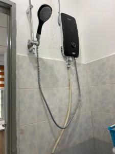 um chuveiro com secador de cabelo na parede em Heaven republic Studio em Kangar