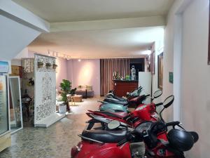 a row of motorcycles parked in a room at GreenHome Hotel in Hai Phong