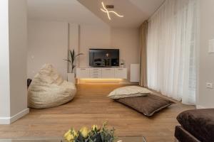 a living room with a couch and a tv at Harmony Sea View Apartment in Thessaloniki