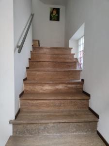 uma escada numa casa com pisos de madeira em Camere D'artista em Enna