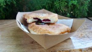 two donuts in a paper bowl on a table at Gasthaus Hundorf in Viişoara