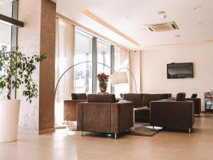 a living room with couches and a tv at Hotel Leone in Međugorje