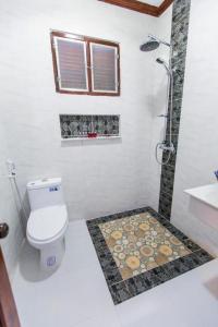 a bathroom with a toilet and a shower and a sink at Moon's house LuangPrabang in Luang Prabang