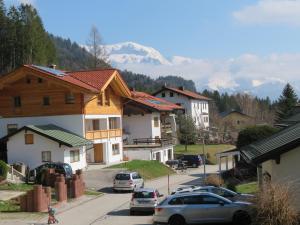 a town with cars parked on a street with mountains at Haus Sternblick in Bischofswiesen