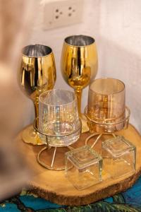 a group of wine glasses on a wooden table at Silsopa Hostel in Nong Khai