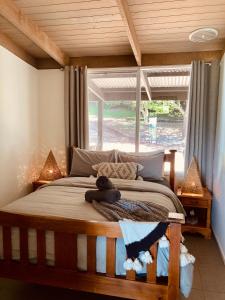 a bedroom with a bed with a teddy bear on it at Elevation652 at Mt Bellevue in King Valley in Myrrhee