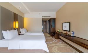 a hotel room with two beds and a flat screen tv at Crowne Plaza Kunming City Centre by IHG in Kunming +239 photos