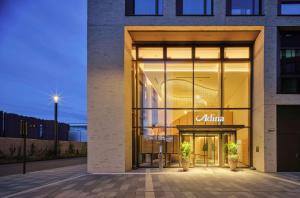 a store front of a building with aania sign on it at Adina Apartment Hotel Cologne in Cologne