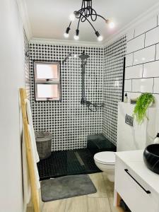 een badkamer met een douche en een toilet. bij Luxurious 2-bedroom beach apartment with a view! in Bloubergstrand