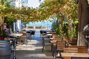 a row of tables and chairs on a patio at Premium Luxury SeaSide Apartment in Burgas City