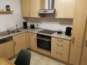 a kitchen with a sink and a stove top oven at Ferientraum-am-Rothaarsteig in Wilnsdorf