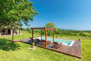 a pool with a wooden deck and a gazebo at Villa Mala Kopa in Barban