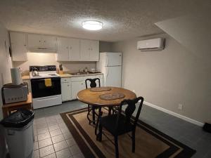 a small kitchen with a table and a refrigerator at Suite 4 - Private Apartment Historical Home in Macon