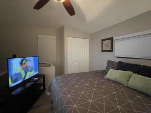 a bedroom with a bed and a flat screen tv at Suite 4 - Private Apartment Historical Home in Macon