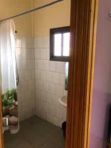 a bathroom with a shower and a sink at AG HOTEL Ouaga in Ouagadougou