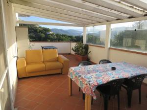 patio con mesa y sofá en el balcón en BANKS 1, en Vezzano Ligure