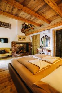 a large bed in a room with a fireplace at AGRITURISMO CA' FENILE in Alzano Lombardo