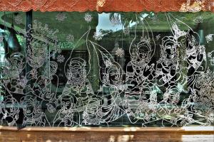 a window of a store with a bunch of skeletons at Sawasdee Village in Kata Beach